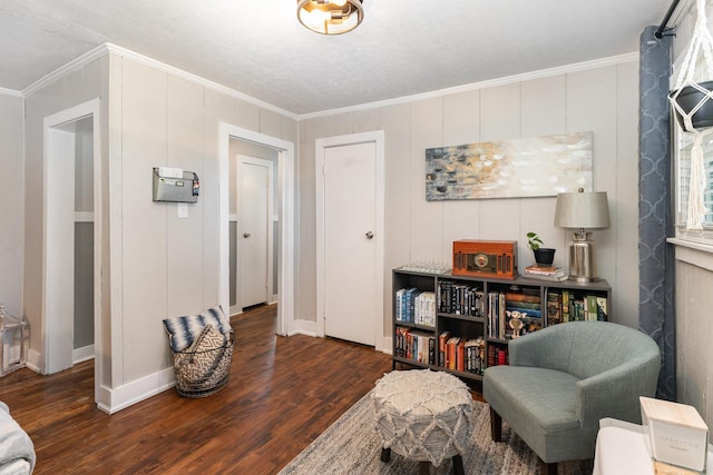 living area featuring wood finished floors, baseboards, and ornamental molding