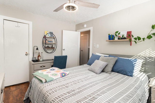 bedroom with dark wood-type flooring and ceiling fan