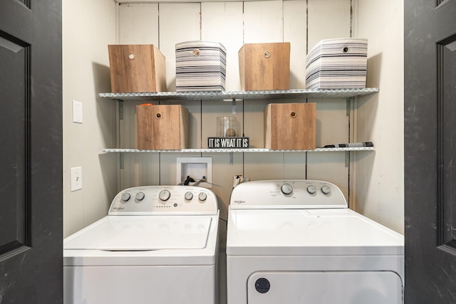 clothes washing area featuring washer and dryer and laundry area