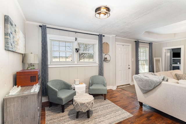 living room featuring crown molding, baseboards, and dark wood-style flooring