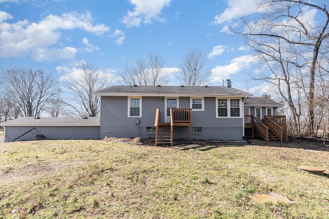 rear view of property featuring stairway, a yard, and a wooden deck