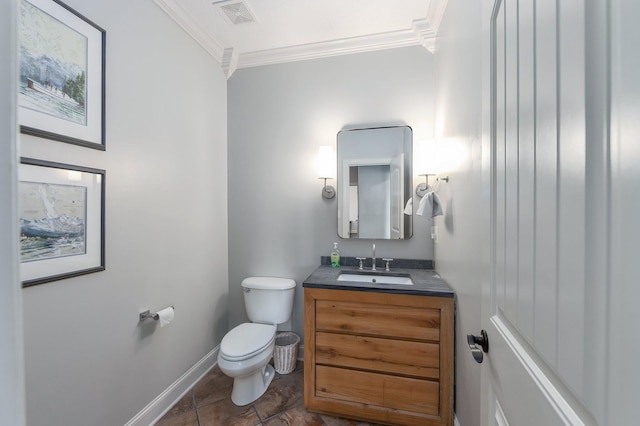 bathroom with visible vents, crown molding, baseboards, toilet, and vanity