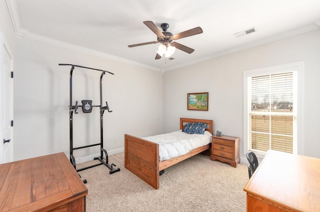 bedroom with visible vents, light carpet, ornamental molding, baseboards, and ceiling fan