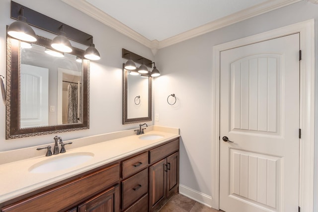 bathroom with double vanity, ornamental molding, baseboards, and a sink