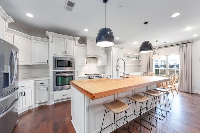 kitchen featuring a sink, dark wood-style flooring, white cabinetry, and stainless steel appliances