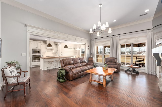 living area featuring visible vents, recessed lighting, dark wood-style flooring, crown molding, and a chandelier