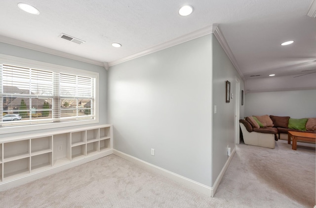 carpeted spare room with a ceiling fan, baseboards, visible vents, recessed lighting, and crown molding