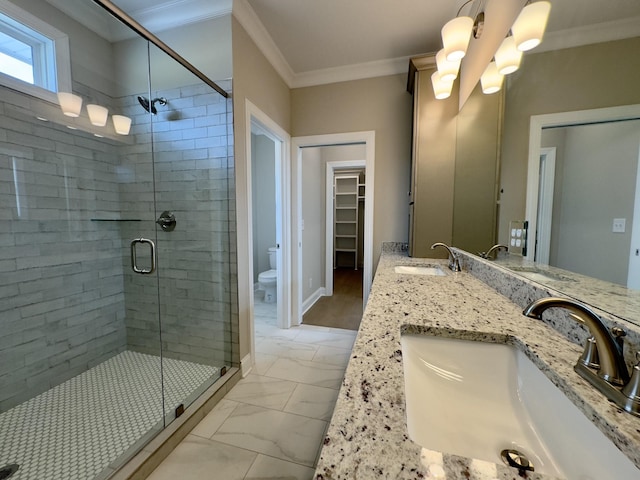 full bath featuring marble finish floor, ornamental molding, and a sink