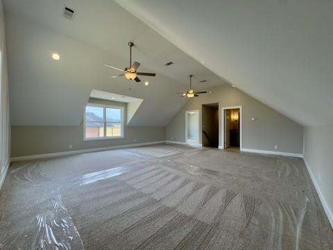 bonus room featuring visible vents, ceiling fan, baseboards, carpet floors, and vaulted ceiling