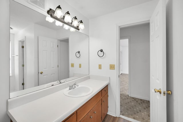 bathroom featuring vanity, baseboards, and visible vents