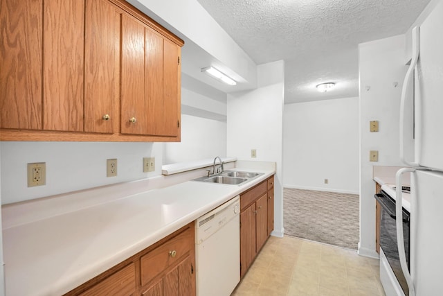 kitchen featuring light countertops, light carpet, white appliances, a textured ceiling, and a sink