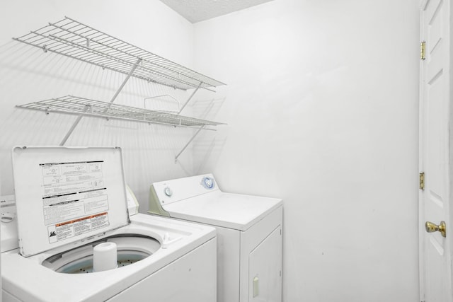 washroom featuring washer and clothes dryer and laundry area