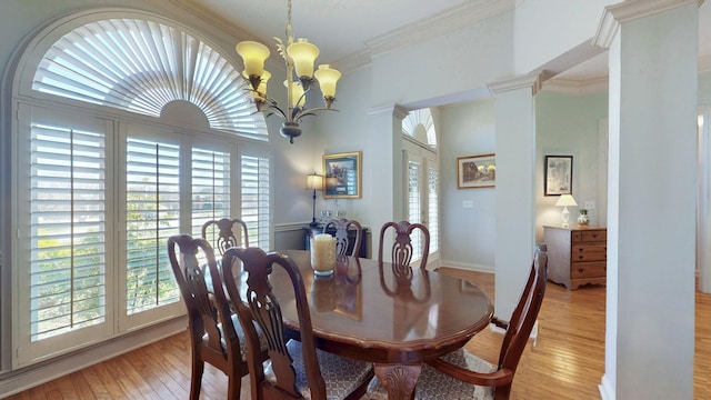 dining area with an inviting chandelier, crown molding, light wood-style flooring, and baseboards