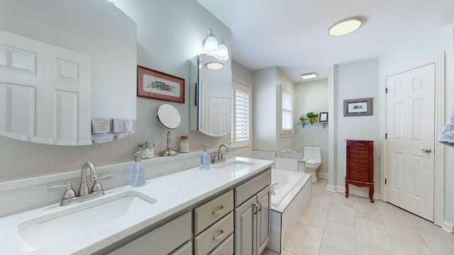 bathroom with tile patterned floors, a bath, double vanity, and a sink