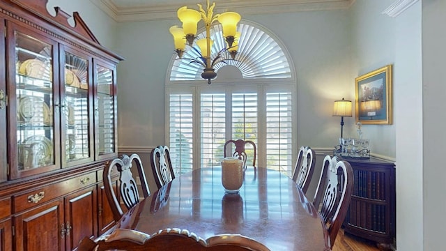 dining area with a notable chandelier and crown molding