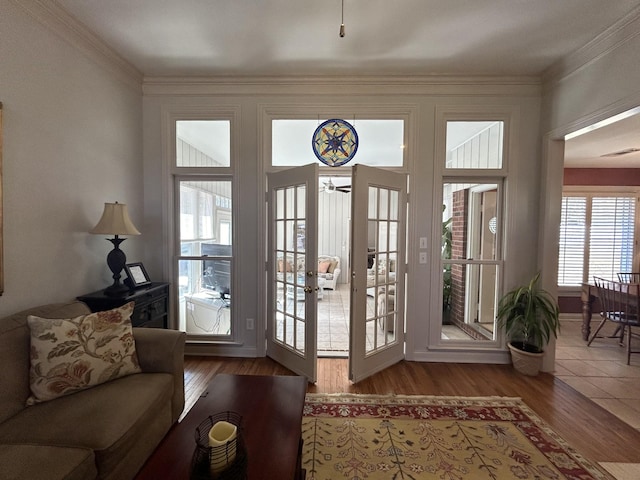 doorway with french doors, wood finished floors, and crown molding