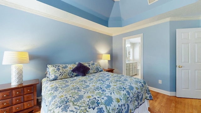 bedroom featuring crown molding, light wood-style floors, baseboards, and connected bathroom