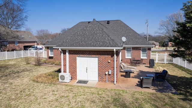 rear view of house with a lawn, a patio, and a fenced backyard