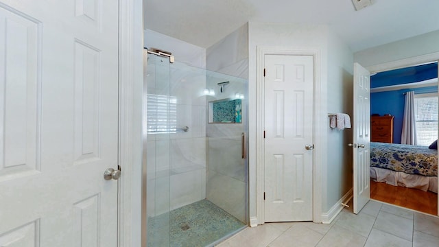 ensuite bathroom featuring baseboards, visible vents, ensuite bath, tile patterned flooring, and a shower stall