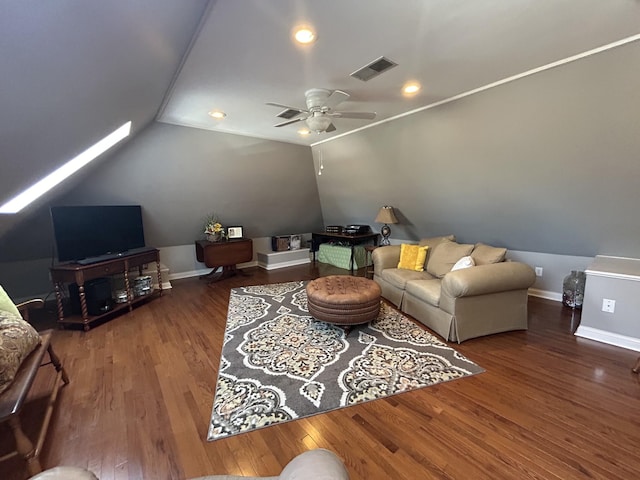 living room with visible vents, baseboards, vaulted ceiling, wood finished floors, and a ceiling fan