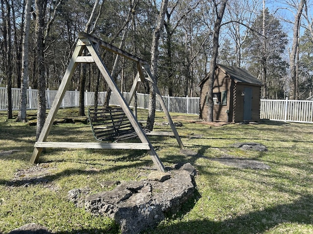 view of yard featuring a fenced backyard, a storage shed, and an outdoor structure