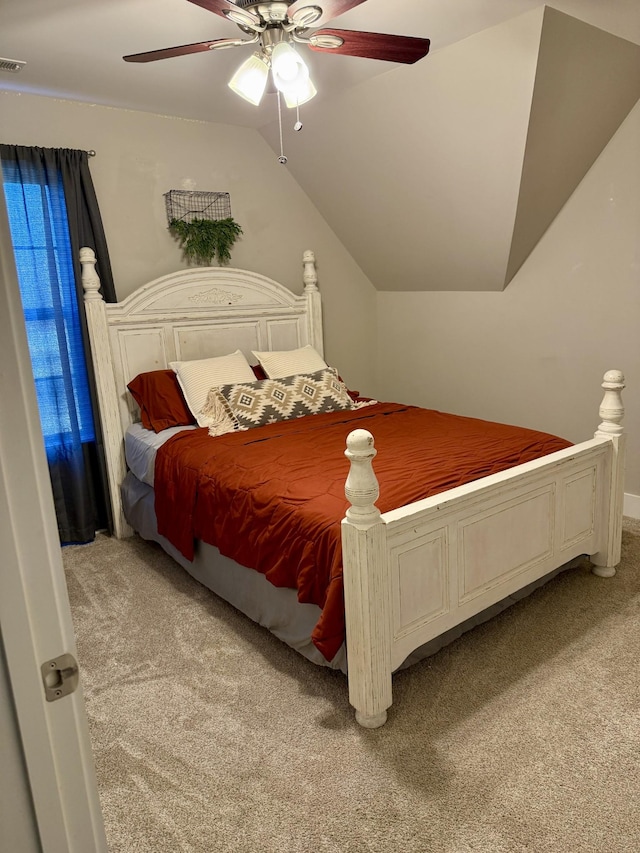 carpeted bedroom featuring vaulted ceiling, a ceiling fan, and visible vents
