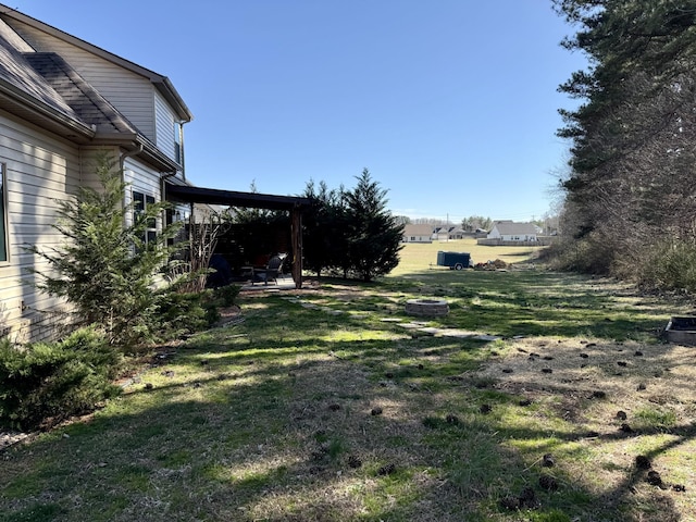 view of yard with a fire pit and a patio area