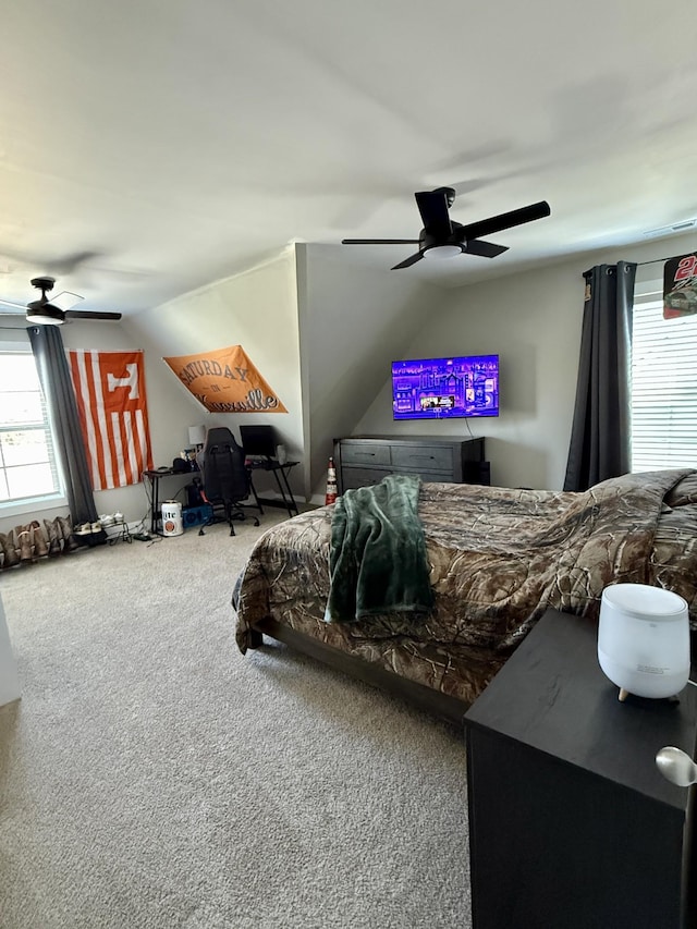 bedroom featuring a ceiling fan, vaulted ceiling, and carpet