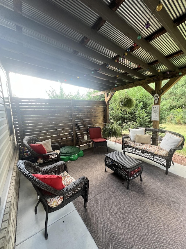 view of patio with an outdoor living space, fence, and a pergola