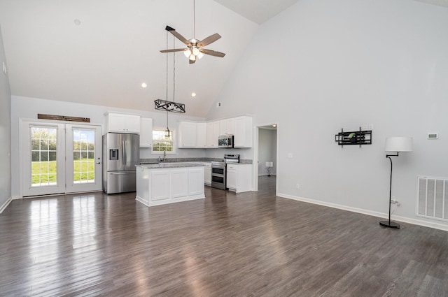 kitchen with visible vents, open floor plan, high vaulted ceiling, and stainless steel appliances