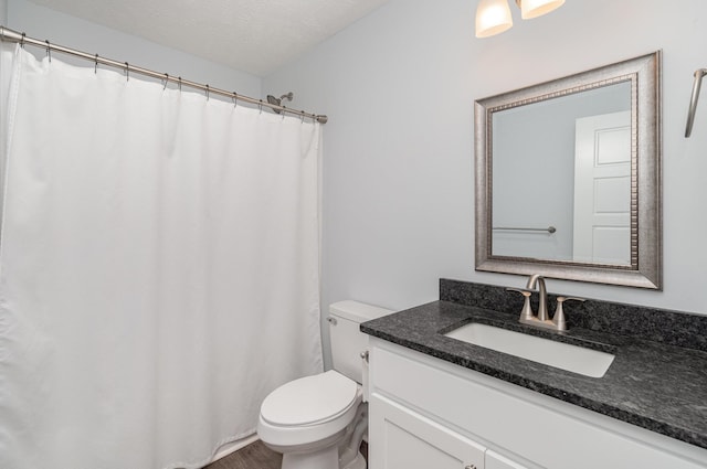 full bathroom with toilet, vanity, and wood finished floors