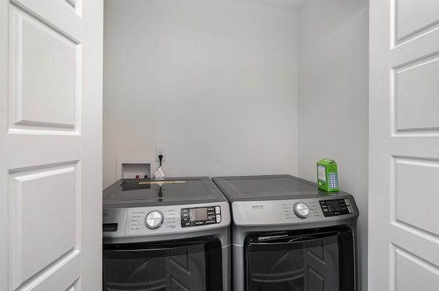 clothes washing area with laundry area and washing machine and clothes dryer