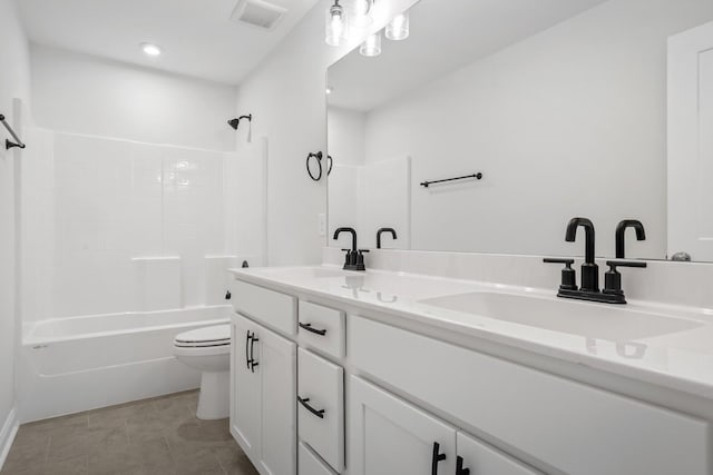 full bath with a sink, visible vents, toilet, and double vanity