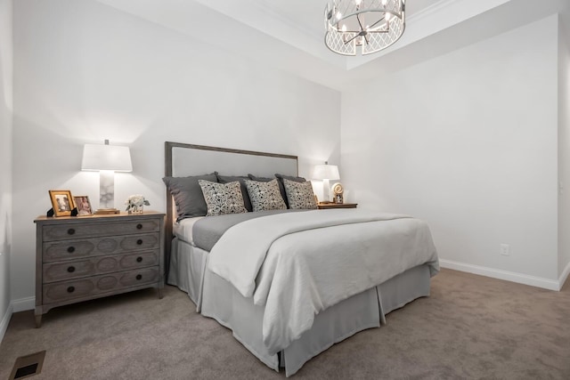 bedroom with baseboards, visible vents, a tray ceiling, light colored carpet, and a chandelier