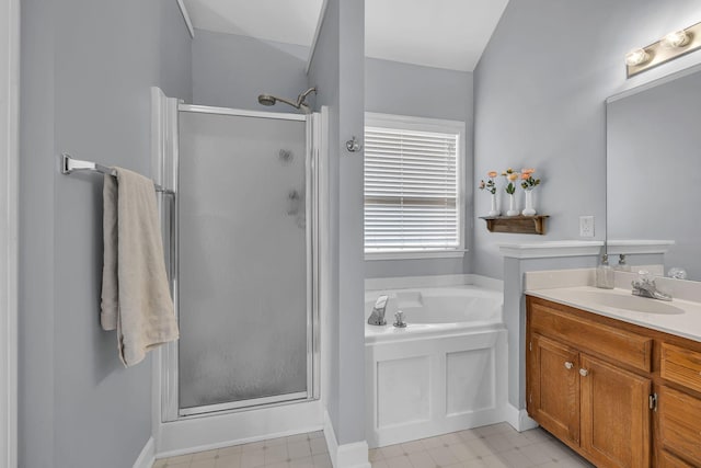 bathroom featuring tile patterned floors, a garden tub, a stall shower, and vanity