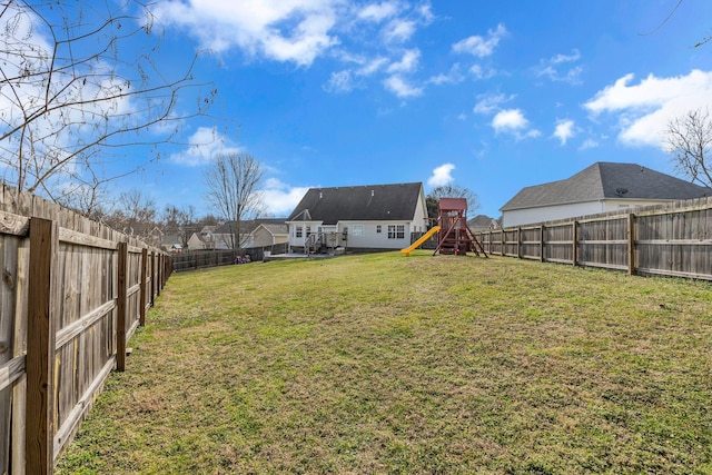 view of yard with a playground and a fenced backyard