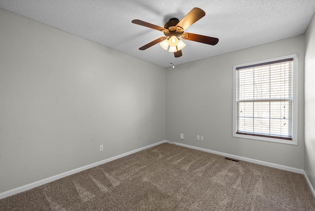 unfurnished room with visible vents, carpet floors, a textured ceiling, and a ceiling fan