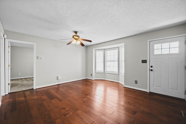 foyer entrance with baseboards, wood-type flooring, a textured ceiling, and ceiling fan