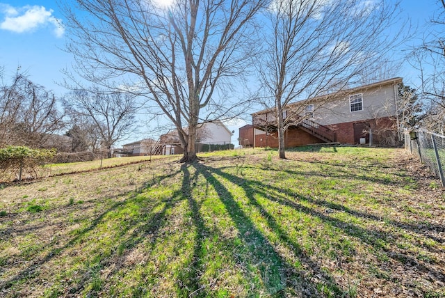 view of yard featuring stairs and a fenced backyard