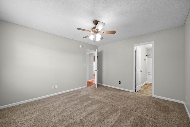 carpeted empty room with a textured ceiling, baseboards, and ceiling fan