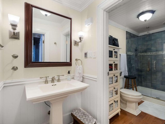 full bath with a wainscoted wall, wood finished floors, a stall shower, and crown molding