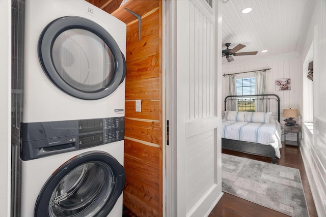 clothes washing area with ceiling fan, laundry area, recessed lighting, stacked washing maching and dryer, and wood finished floors