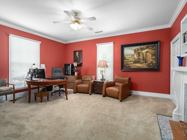 office area featuring visible vents, crown molding, baseboards, carpet flooring, and a ceiling fan