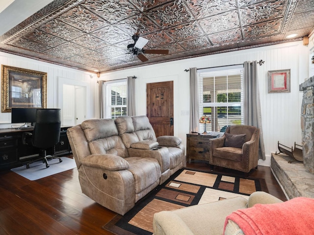 living area featuring hardwood / wood-style floors, crown molding, an ornate ceiling, and ceiling fan