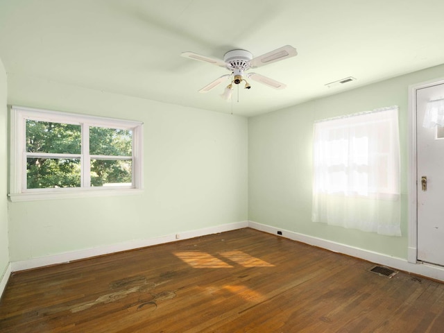 unfurnished room featuring visible vents, a ceiling fan, and hardwood / wood-style flooring