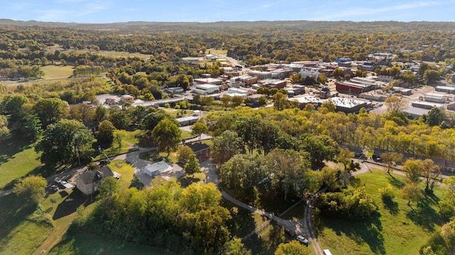 drone / aerial view featuring a wooded view