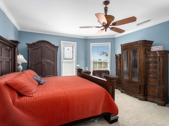 bedroom featuring visible vents, light carpet, ornamental molding, and a ceiling fan