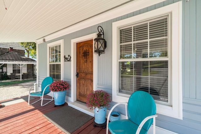 view of exterior entry with covered porch