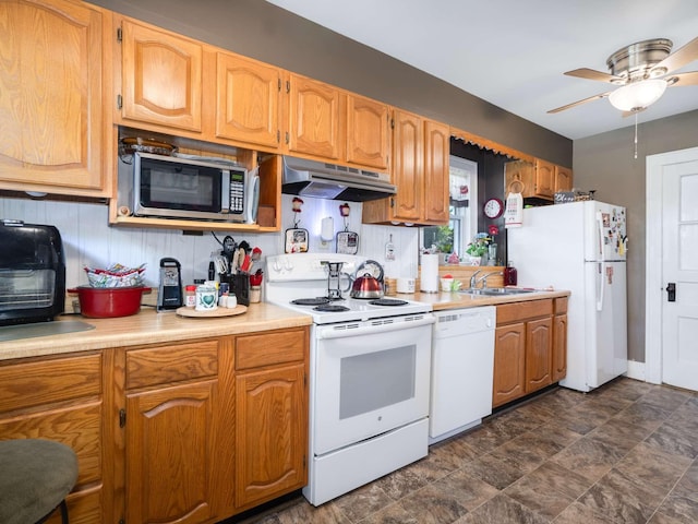 kitchen with under cabinet range hood, a sink, white appliances, light countertops, and ceiling fan