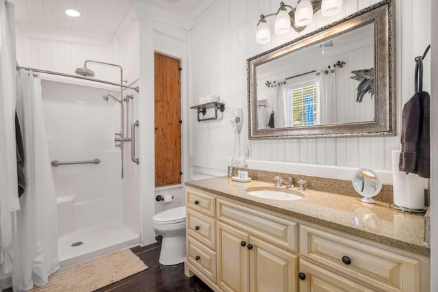 full bath with wood finished floors, toilet, a stall shower, and vanity